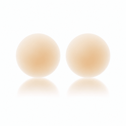 Seamless reusable nipple covers in Creme, shown as a pair